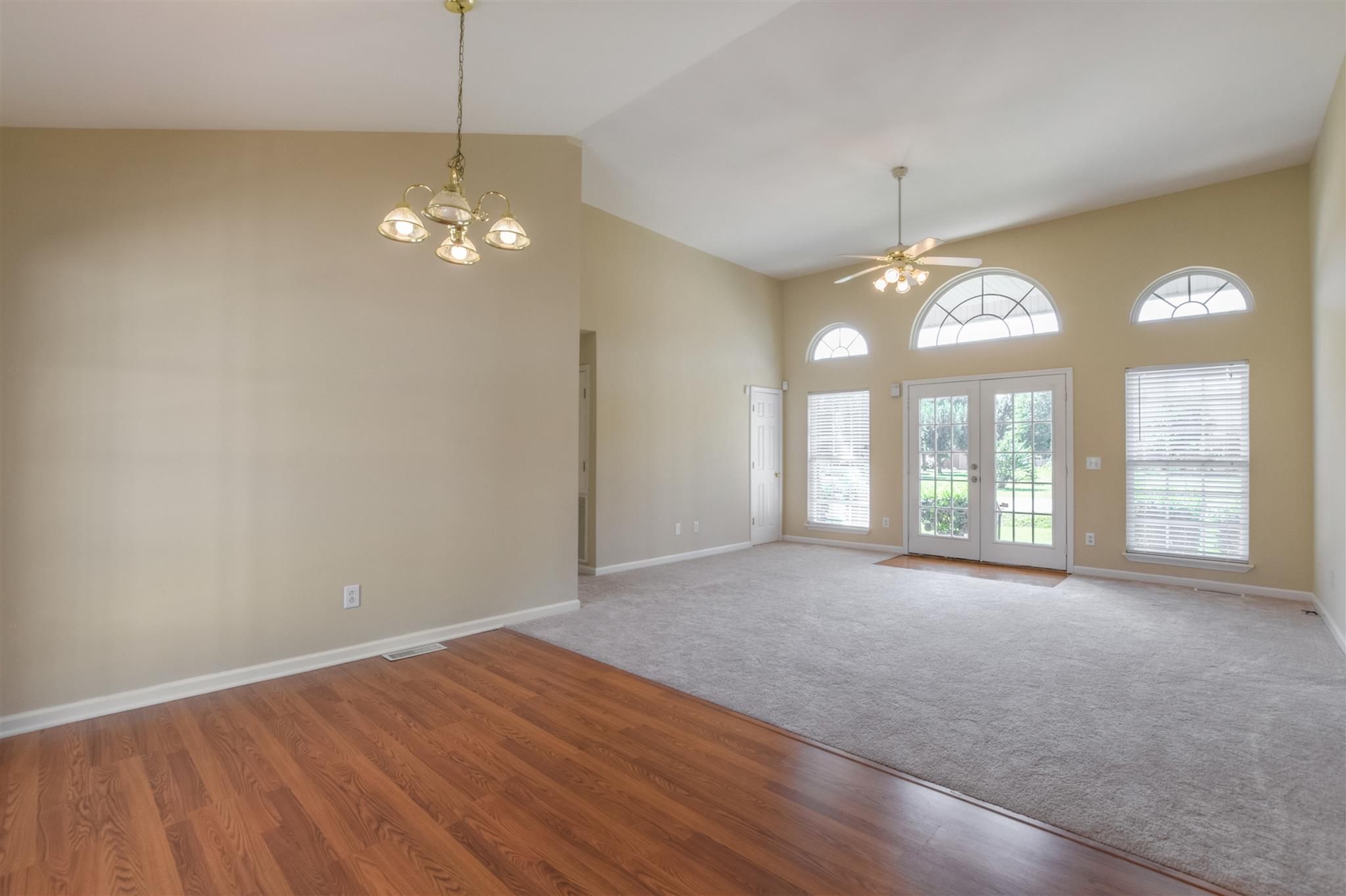 516 Windy Road Mount Juliet, TN 37122 - Photo 5 of 30 a view of an empty room with a chandelier fan and a window