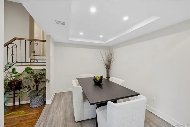 a view of a workspace with furniture and wooden floor