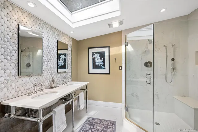 a bathroom with a sink a mirror and a shower