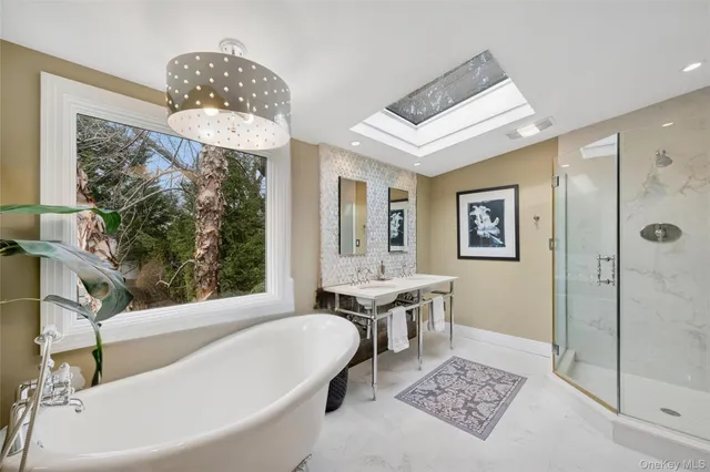 a bath room with a toilet a bath tub and a shower