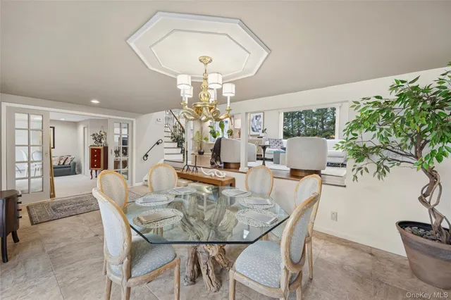 a view of a dining room with furniture and chandelier