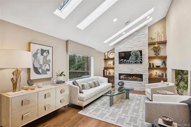 a spacious bedroom with furniture and a fireplace