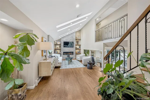 a living room with furniture dining table a potted plant and a potted plant