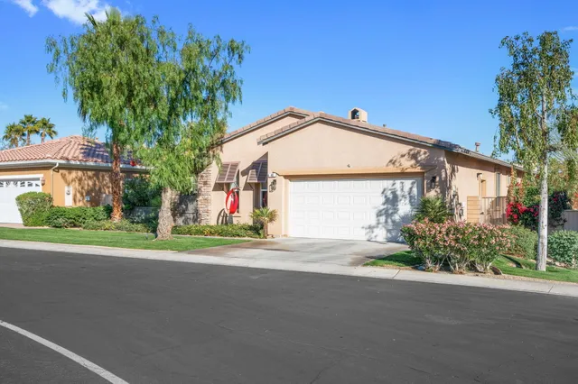 a front view of a house with a yard and a garage