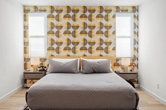 a bedroom with a bed and a lamp