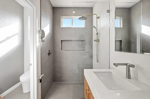 a bathroom with a tub sink and mirror