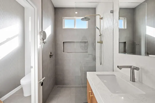 a bathroom with a tub sink and mirror