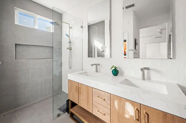 a bathroom with a double vanity sink and a mirror