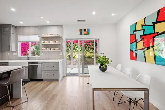 a kitchen with cabinets and wooden floor