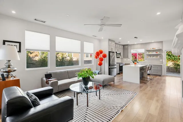 a living room with furniture and a wooden floor