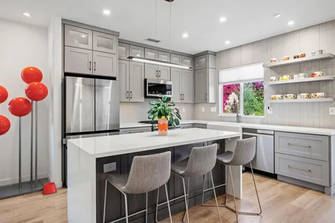 a kitchen with stainless steel appliances a refrigerator sink and microwave