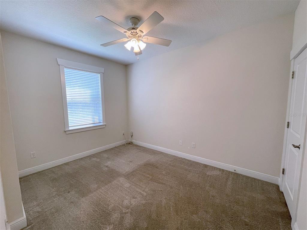 2411 West North A Street, Unit 2 Tampa, FL 33609 - Photo 3 of 19 an empty room with a chandelier fan