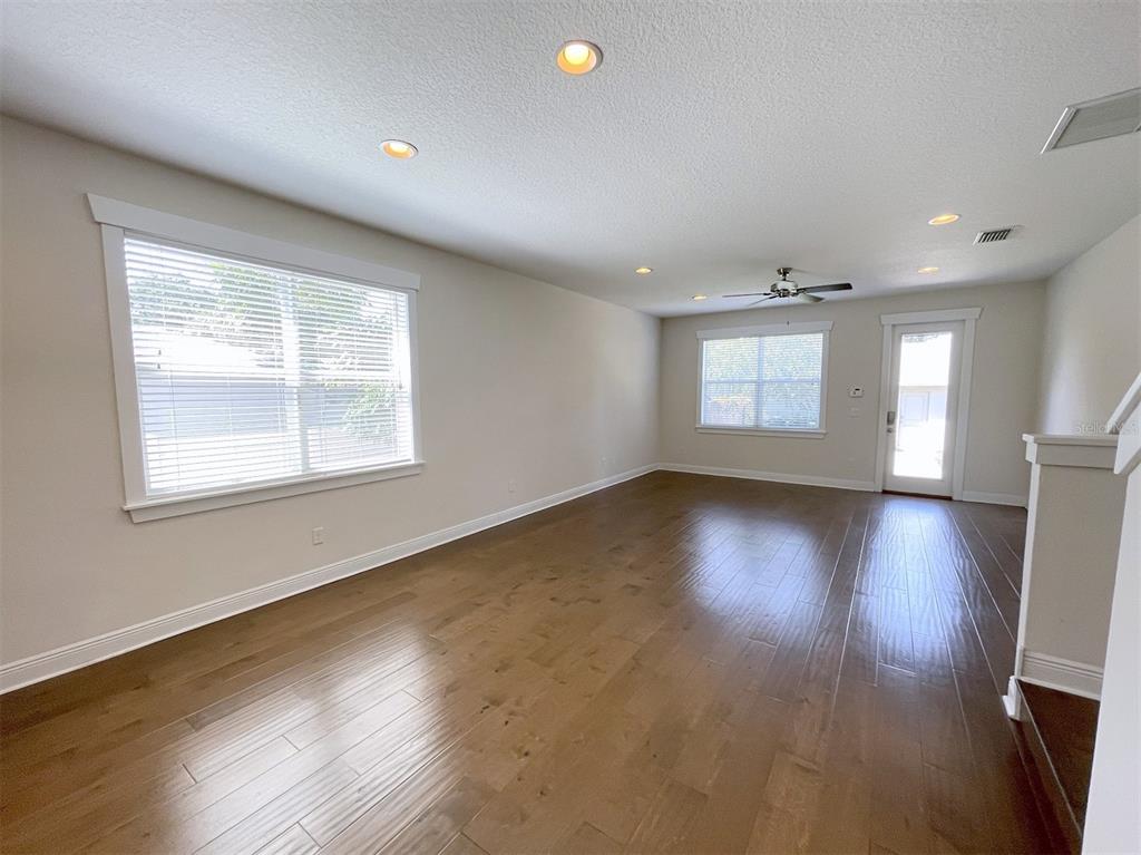2411 West North A Street, Unit 2 Tampa, FL 33609 - Photo 5 of 19 an empty room with wooden floor and windows