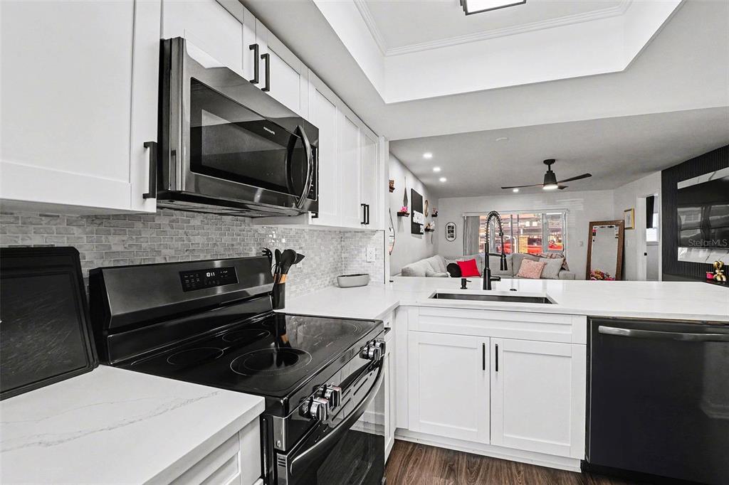 5197 Silent Loop, Unit 121 New Port Richey, FL 34652 - Photo 11 of 36 a kitchen with a stove and a microwave