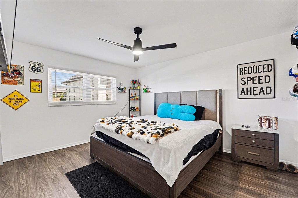 5197 Silent Loop, Unit 121 New Port Richey, FL 34652 - Photo 16 of 36 a bedroom with a bed and wooden floor