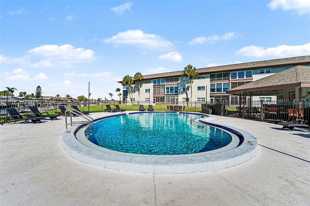 5197 Silent Loop, Unit 121 New Port Richey, FL 34652 - Photo 23 of 36 a view of a swimming pool with outdoor seating