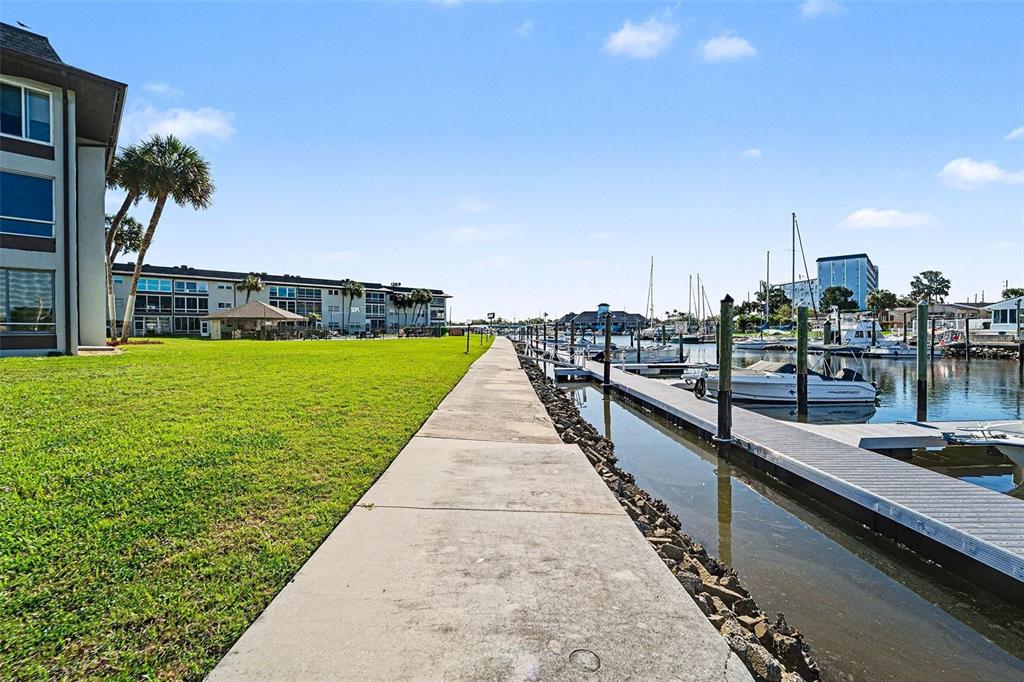 5197 Silent Loop, Unit 121 New Port Richey, FL 34652 - Photo 27 of 36 a view of a swimming pool with a lawn chairs