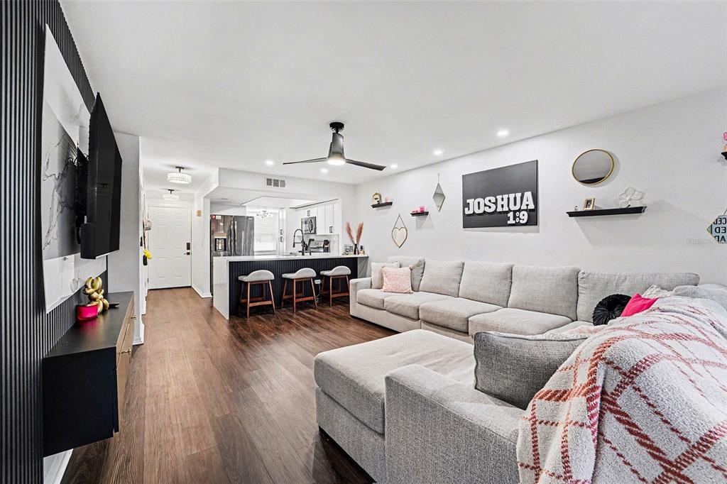 5197 Silent Loop, Unit 121 New Port Richey, FL 34652 - Photo 4 of 36 a living room with furniture and wooden floor
