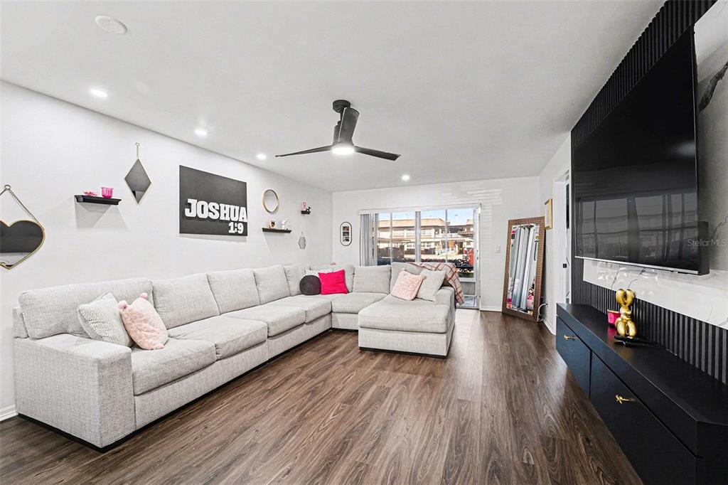 5197 Silent Loop, Unit 121 New Port Richey, FL 34652 - Photo 5 of 36 a living room with furniture and a flat screen tv