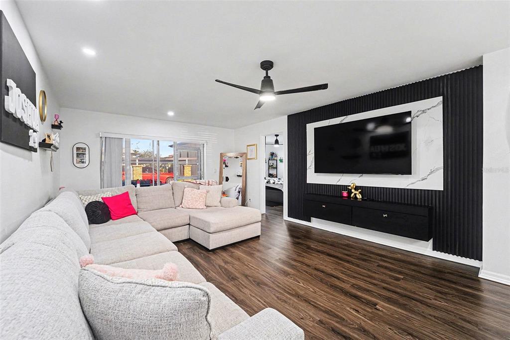 5197 Silent Loop, Unit 121 New Port Richey, FL 34652 - Photo 6 of 36 a living room with furniture and a flat screen tv