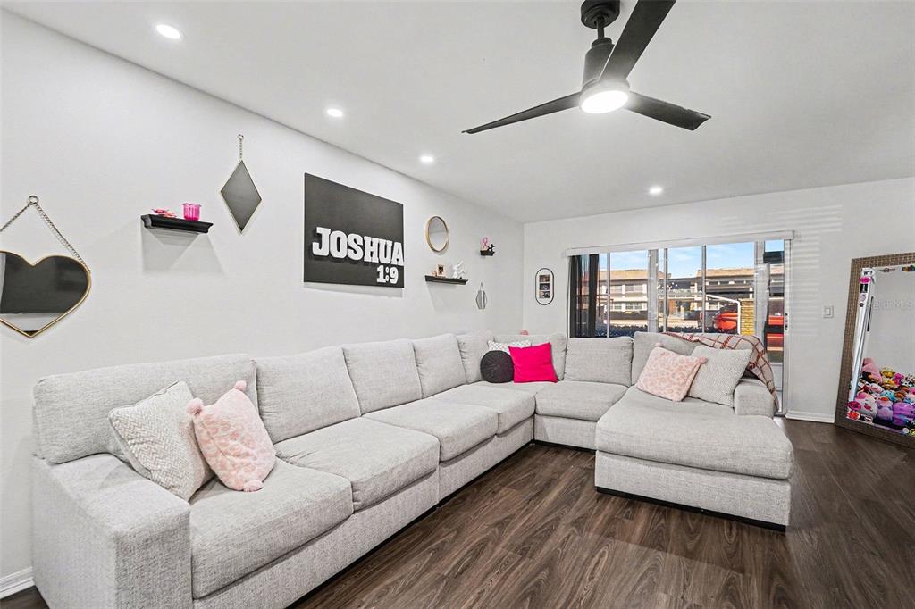 5197 Silent Loop, Unit 121 New Port Richey, FL 34652 - Photo 7 of 36 a living room with furniture and a wooden floor