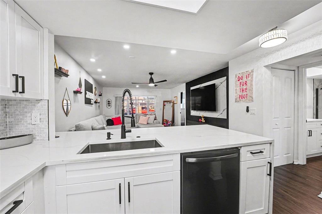 5197 Silent Loop, Unit 121 New Port Richey, FL 34652 - Photo 10 of 36 a kitchen view with microwave a stove and a refrigerator with wooden floor