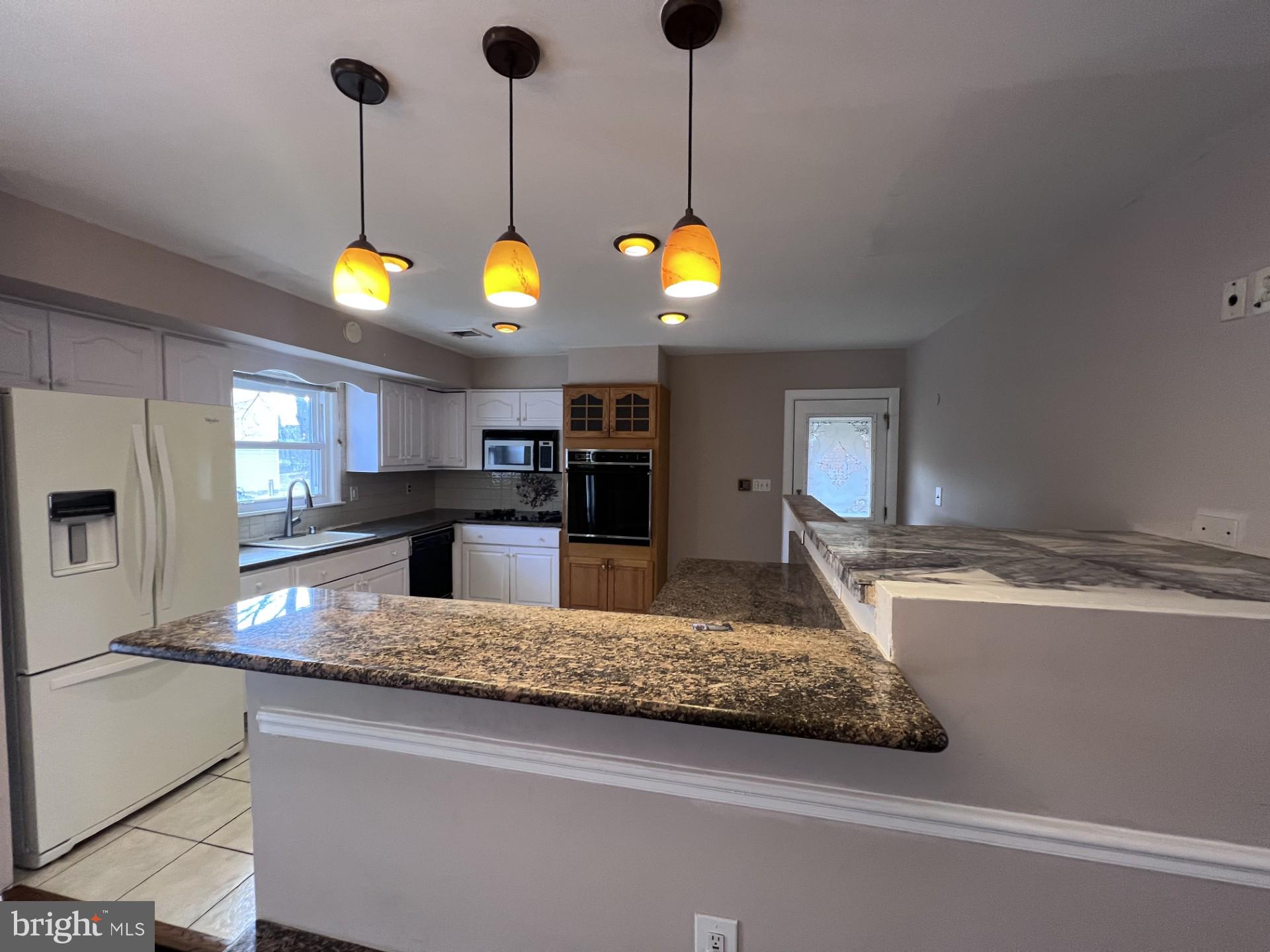 3620 Marlbrough Way College Park, MD 20740 - Photo 5 of 30 a kitchen with kitchen island a counter space a sink and appliances