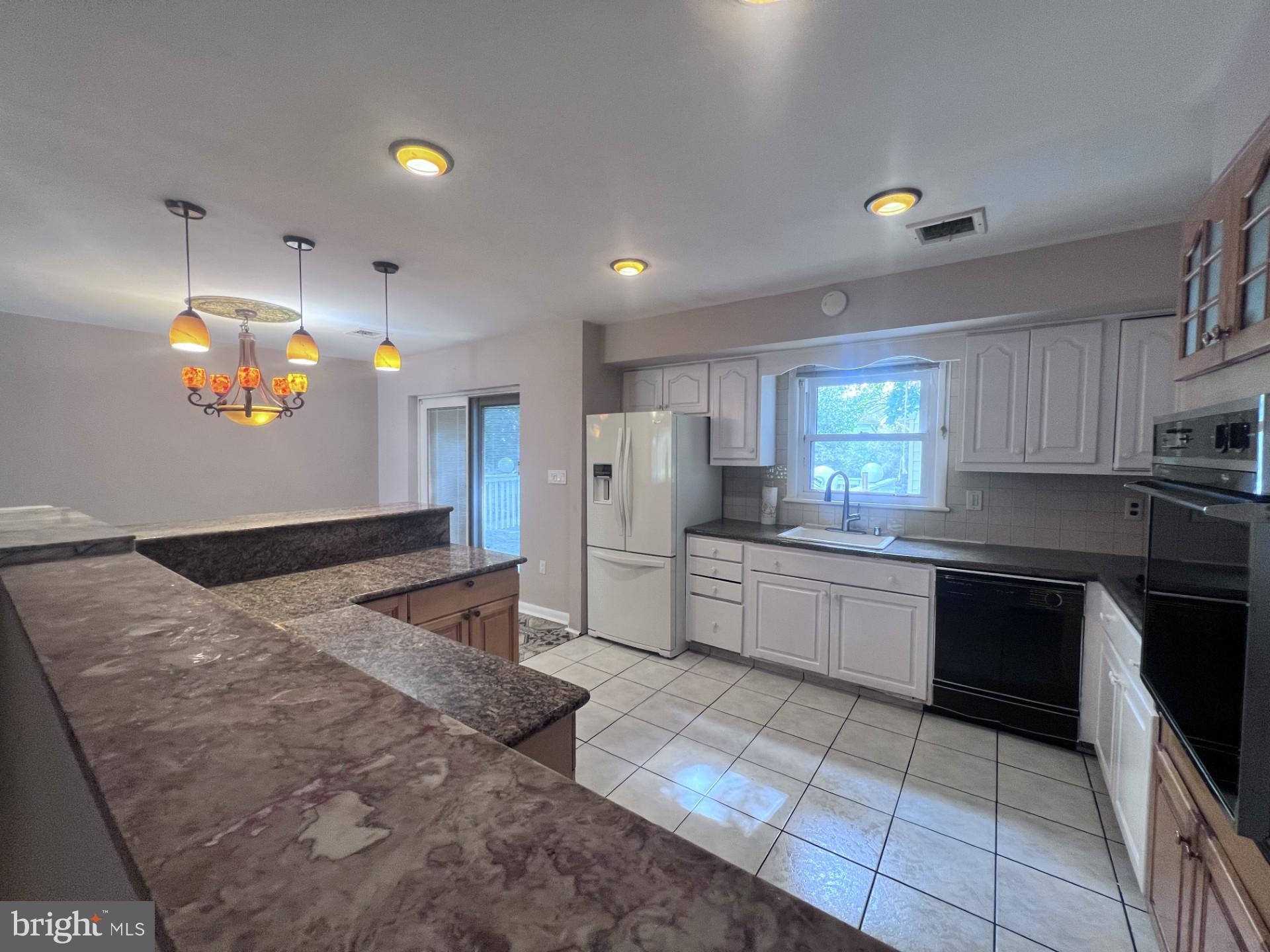 3620 Marlbrough Way College Park, MD 20740 - Photo 6 of 30 a large kitchen with stainless steel appliances kitchen island granite countertop a sink and cabinets