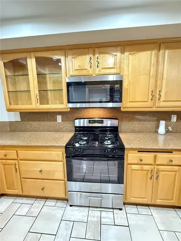 a stove top oven sitting inside of a kitchen