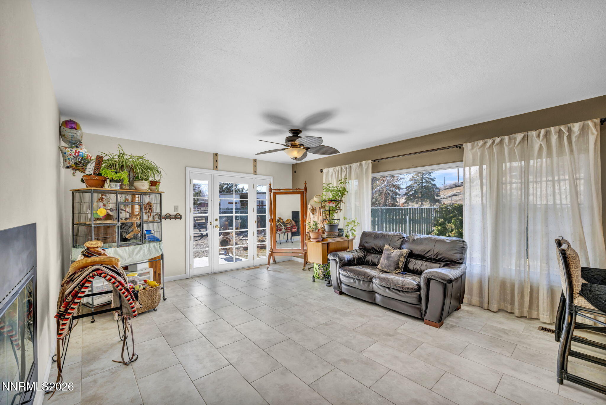 10200 Shiloh Drive Reno, NV 89508 - Photo 14 of 37 a living room with furniture and a floor to ceiling window