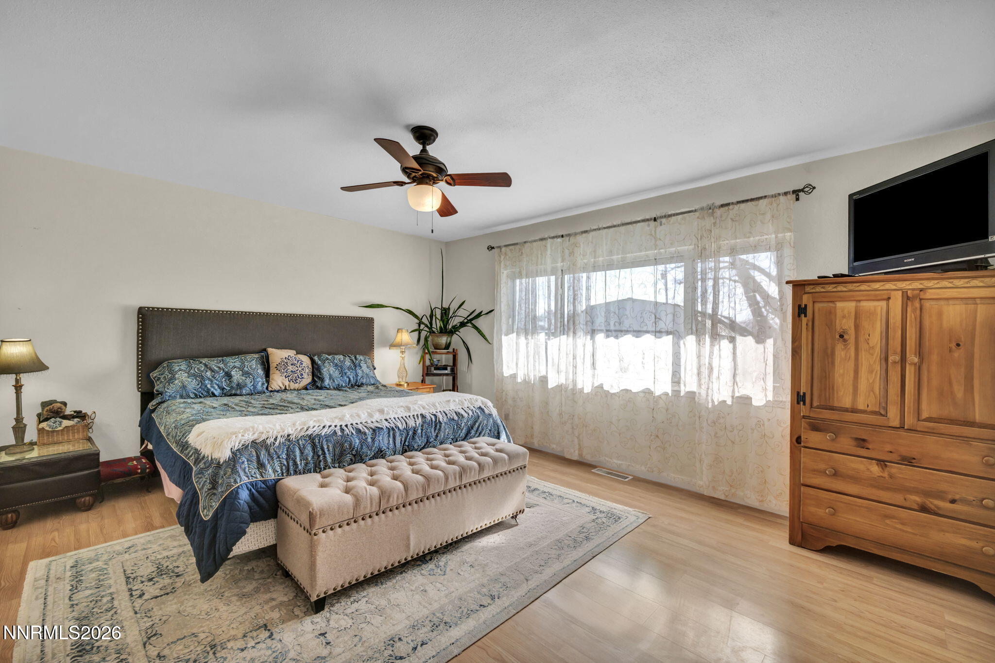 10200 Shiloh Drive Reno, NV 89508 - Photo 15 of 37 a spacious bedroom with a bed flat screen tv and a window