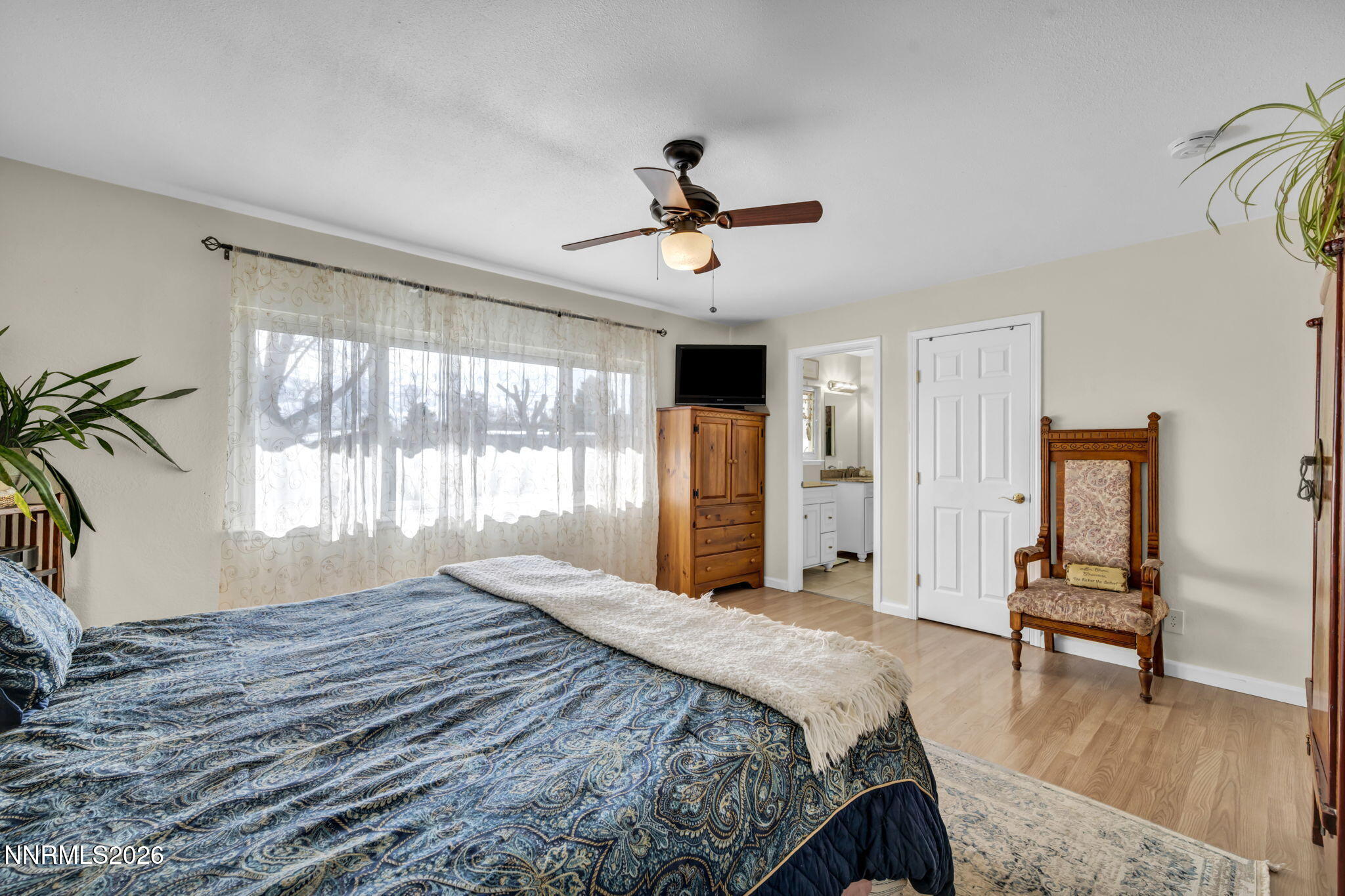 10200 Shiloh Drive Reno, NV 89508 - Photo 16 of 37 a bedroom with a bed and a chandelier