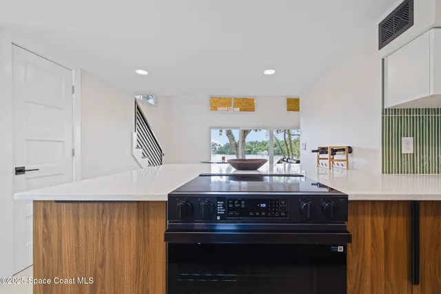 a kitchen with stainless steel appliances a sink cabinets and wooden floor