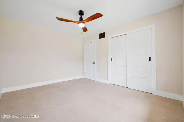 an empty room with a window and wooden floor