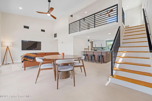 a dining room with furniture and wooden floor