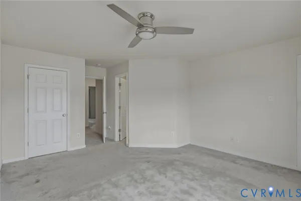 a view of a room with wooden floor and windows