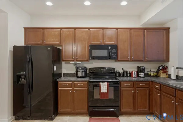 an empty room with wooden floor cabinet and windows