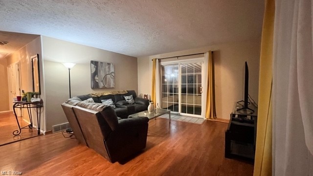 5890 Randy Road Bedford, OH 44146 - Photo 4 of 20 Living room featuring light hardwood floors and a textured ceiling