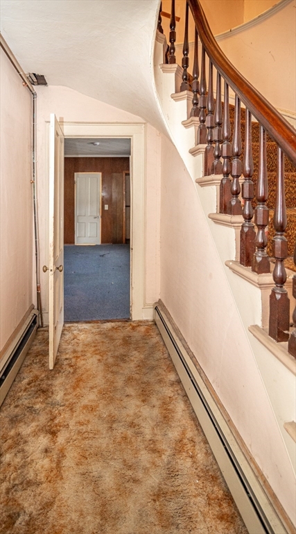 21 Park Street Webster, MA 01570 - Photo 11 of 38 a view of a hallway with wooden walls and stairs