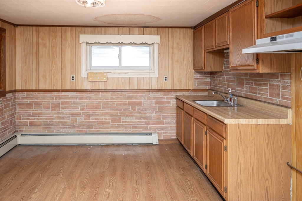 21 Park Street Webster, MA 01570 - Photo 2 of 38 a bathroom with a sink and a bathtub