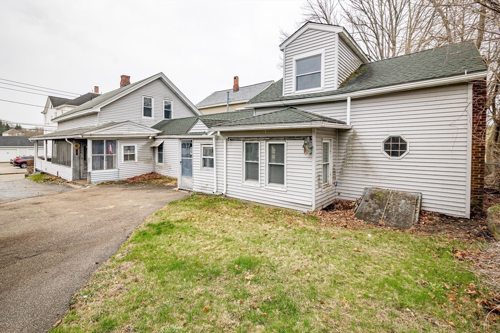 21 Park Street Webster, MA 01570 - Photo 22 of 38 a view of a white house next to a yard with big trees