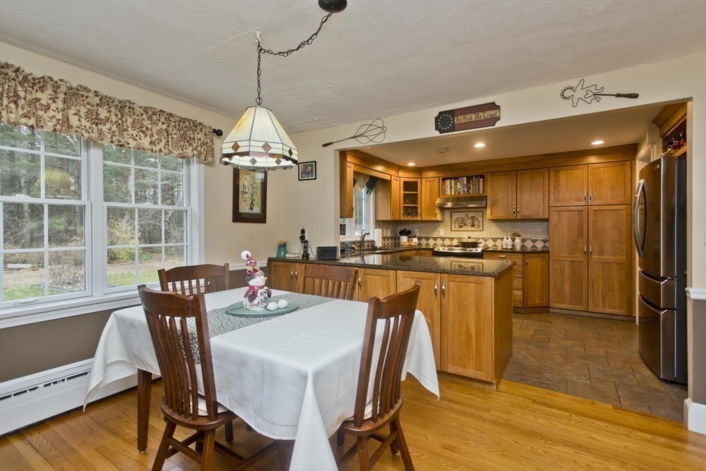 6 West Colonial Road Wilbraham, MA 01095 - Photo 12 of 34 a dining room with furniture a chandelier and wooden floor