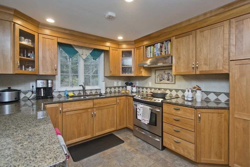 6 West Colonial Road Wilbraham, MA 01095 - Photo 10 of 34 a kitchen with stainless steel appliances granite countertop a stove sink and cabinets