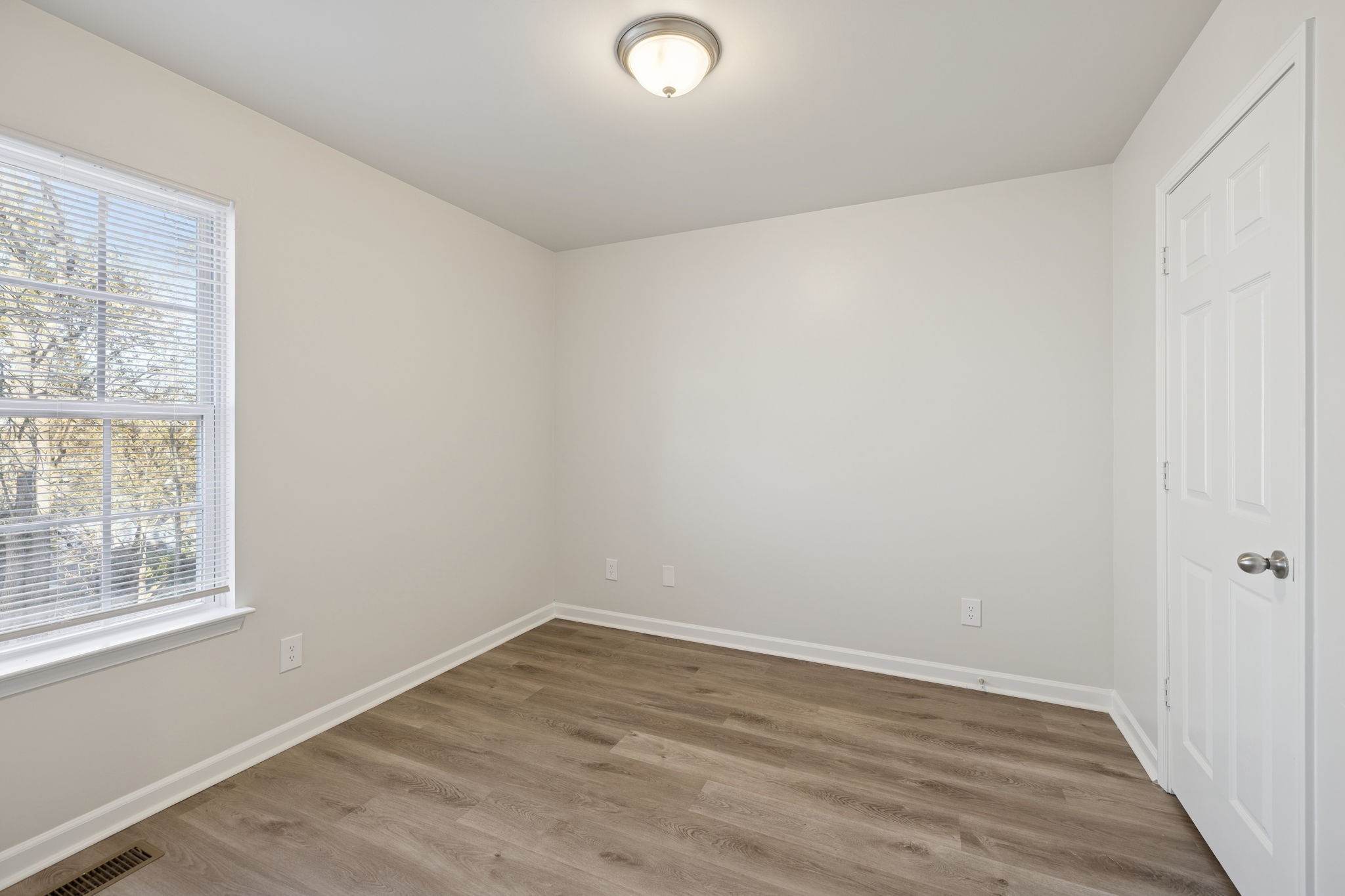 8010 Tiger Court Spring Hill, TN 37174 - Photo 25 of 36 wooden floor in an empty room with a window