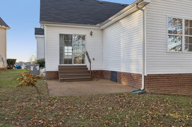 a view of house with backyard and garden