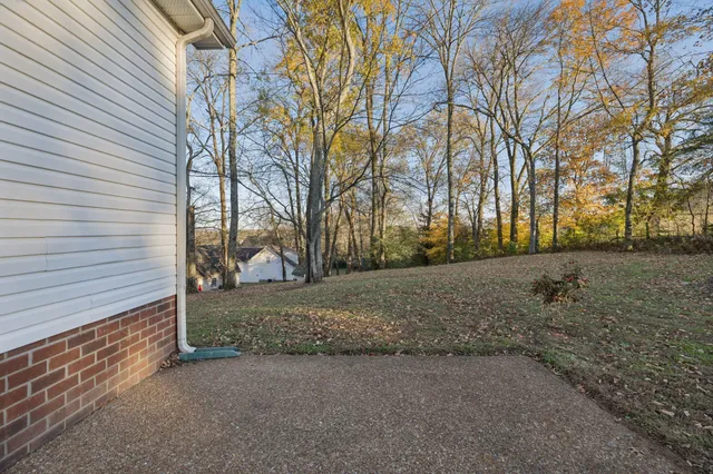 a view of a yard covered with snow in front of house