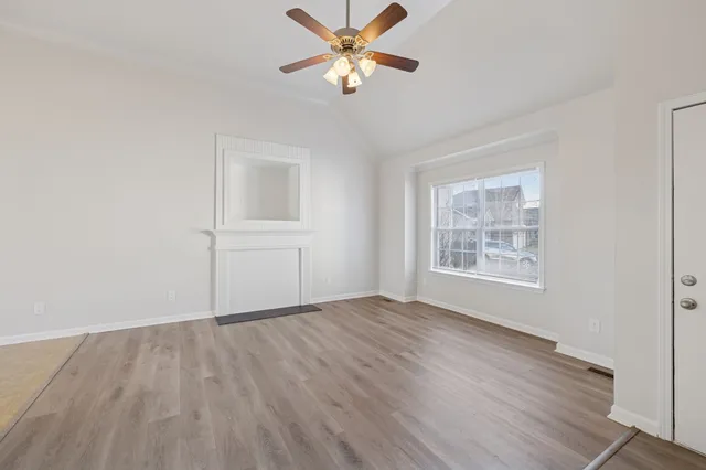 wooden floor in an empty room with a window