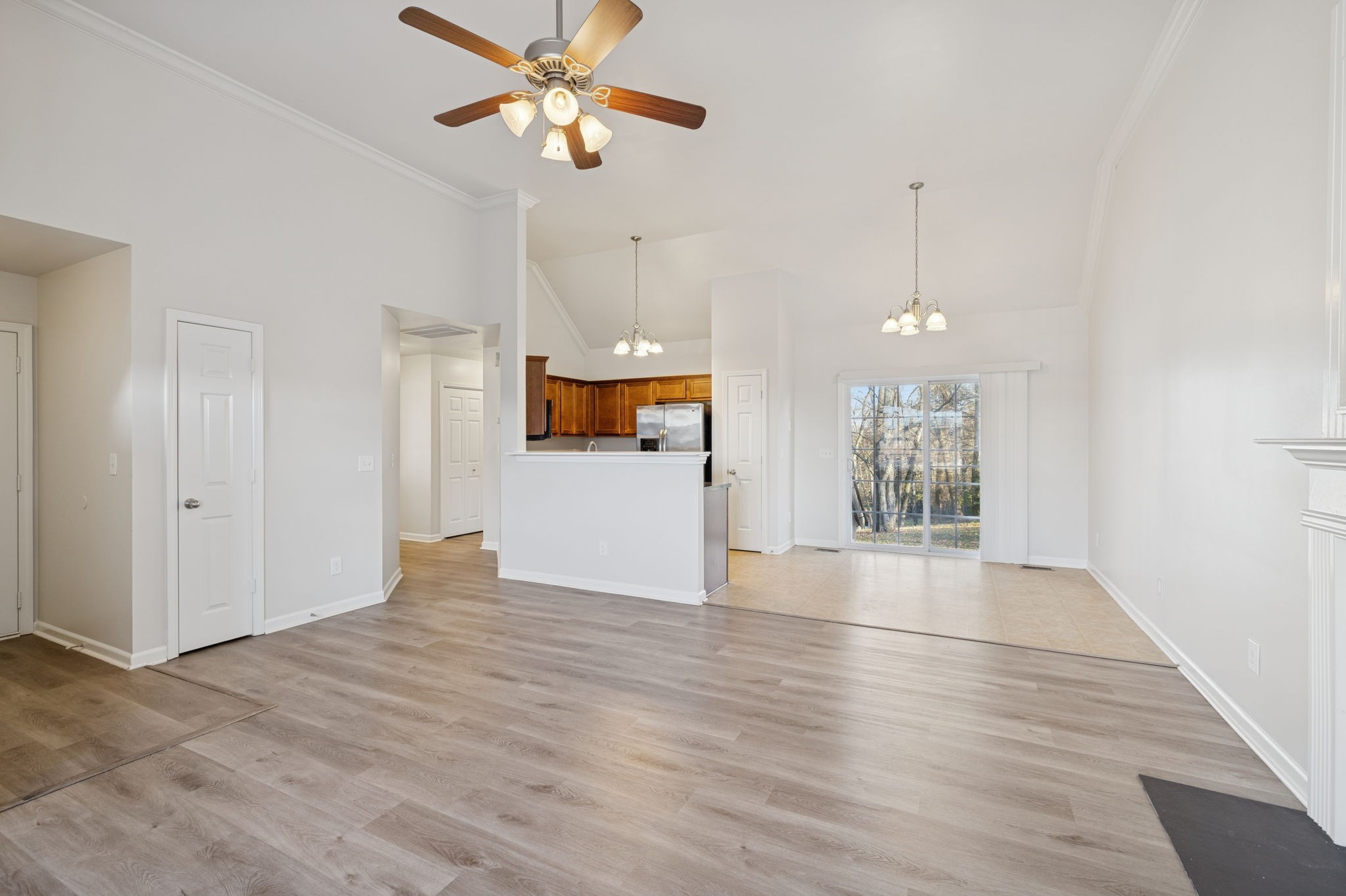 8010 Tiger Court Spring Hill, TN 37174 - Photo 6 of 36 a view of a kitchen with a dishwasher cabinets and wooden floor