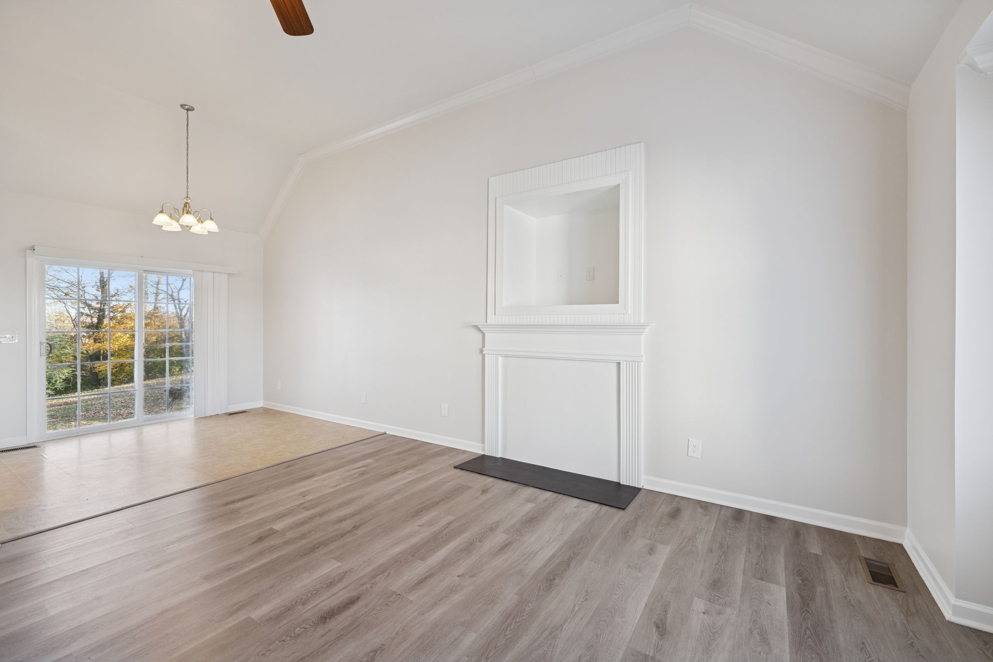 8010 Tiger Court Spring Hill, TN 37174 - Photo 7 of 36 an empty room with wooden floor cabinet and windows
