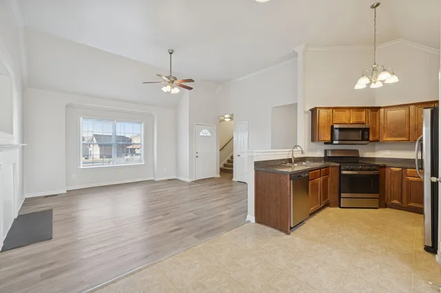 a kitchen with stove cabinets and refrigerator